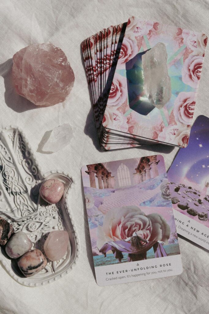 Tarot and crystals on a soft white background for spiritual guidance and healing.